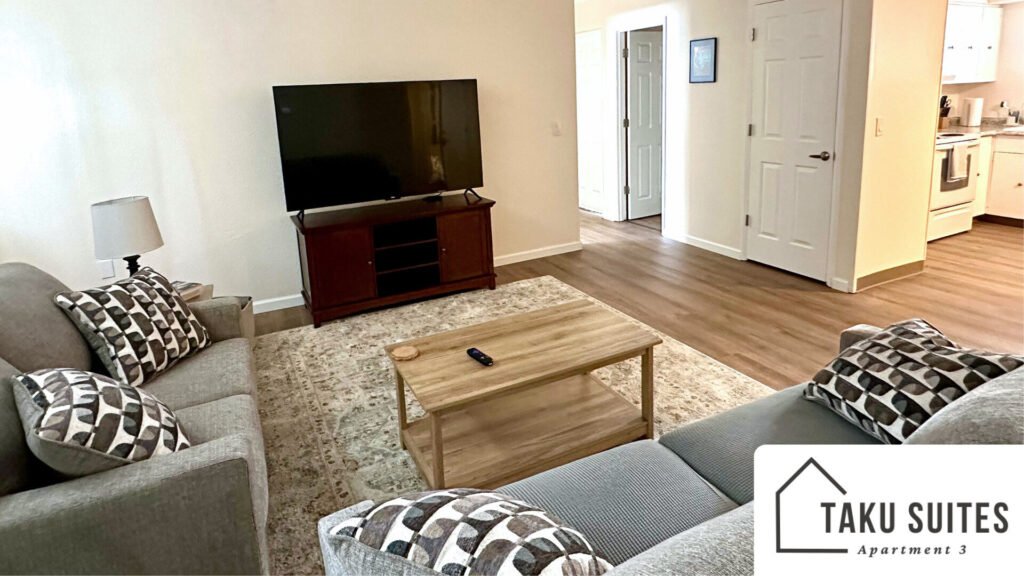 Comfortable living room featuring a couch and love seat, tv, and table